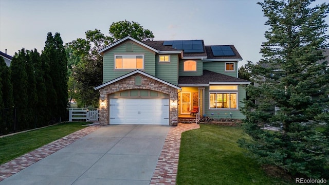 6266 Holman St, Arvada, CO 80004 - view of front of house with stone siding, driveway, and roof mounted solar panels