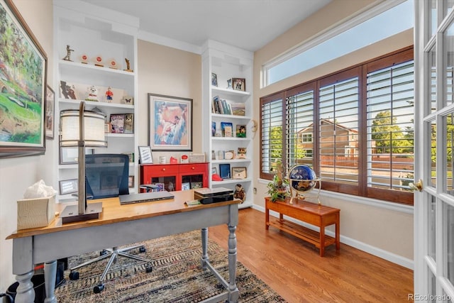 6266 Holman St, Arvada, CO 80004 - office area featuring wood finished floors, baseboards, and built in features