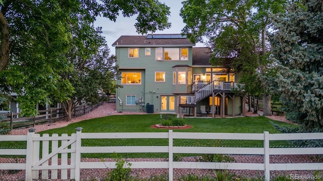6266 Holman St, Arvada, CO 80004 - back of property with central AC unit, solar panels, a deck, and a shingled roof