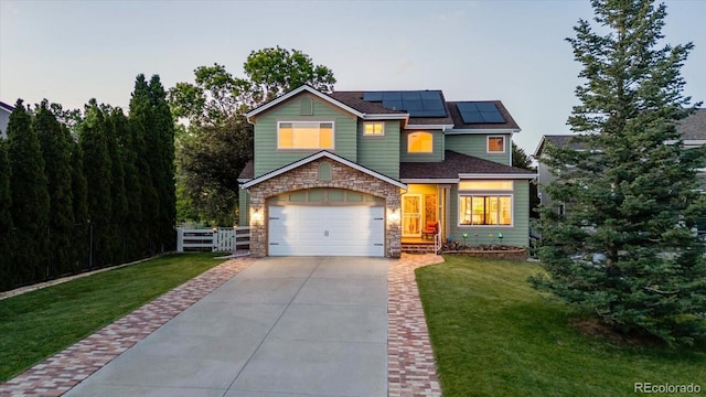 6266 Holman St, Arvada, CO 80004 - view of front of house featuring driveway, roof mounted solar panels, and stone siding