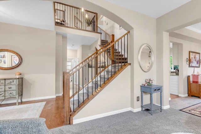 6266 Holman St, Arvada, CO 80004 - stairs featuring baseboards, arched walkways, and carpet flooring