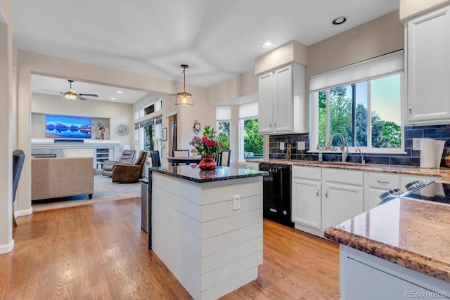 6266 Holman St, Arvada, CO 80004 - kitchen with dishwasher, dark stone counters, backsplash, healthy amount of natural light, and recessed lighting