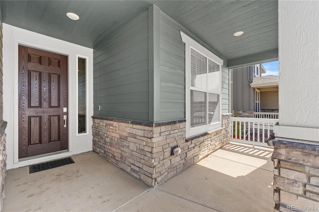 view of exterior entry with covered porch