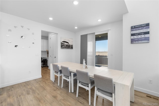 dining room featuring visible vents, light wood-style flooring, recessed lighting, and baseboards