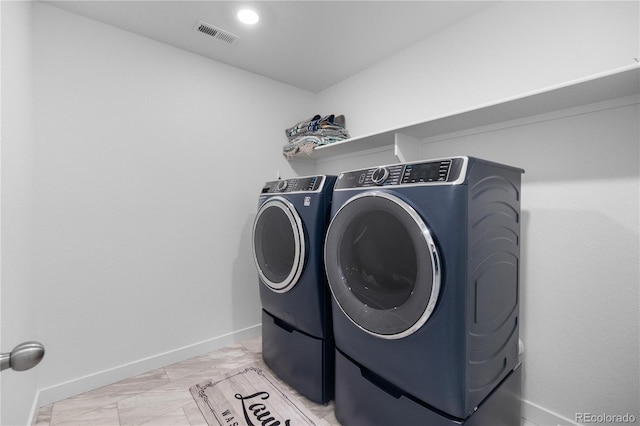 laundry area with visible vents, marble finish floor, separate washer and dryer, baseboards, and laundry area