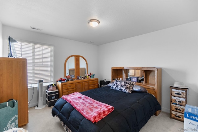 bedroom featuring light carpet and visible vents