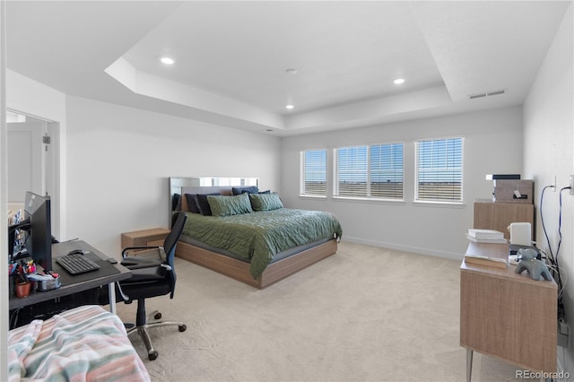 bedroom with visible vents, a tray ceiling, recessed lighting, baseboards, and light colored carpet