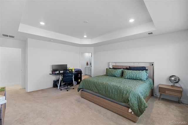 carpeted bedroom featuring a tray ceiling, recessed lighting, and visible vents