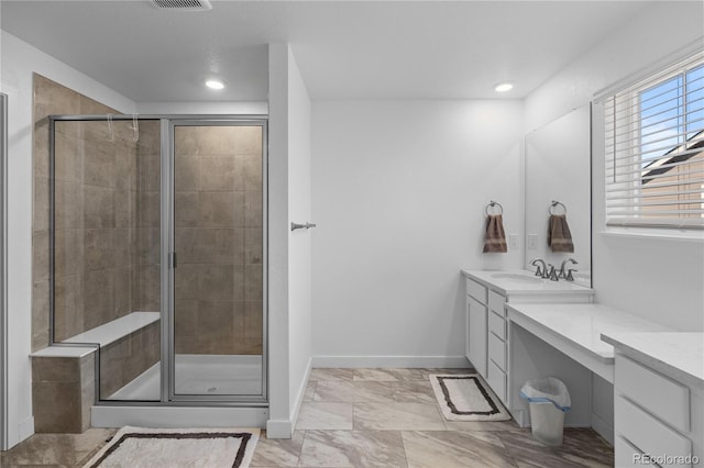 full bathroom with marble finish floor, a stall shower, and vanity