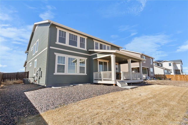 view of front of property with covered porch, cooling unit, and fence