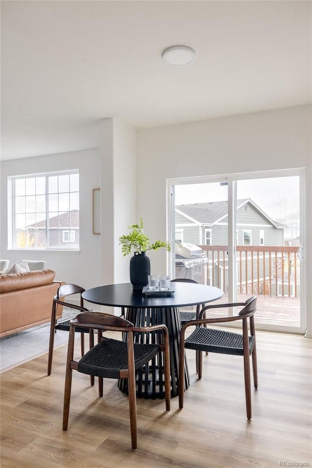 dining space featuring light wood-type flooring