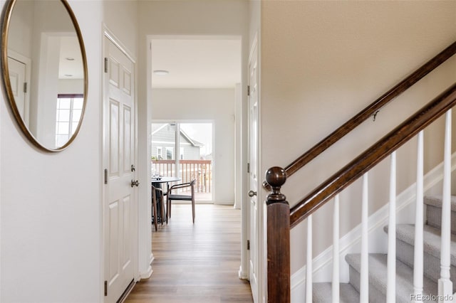 hallway with light hardwood / wood-style floors