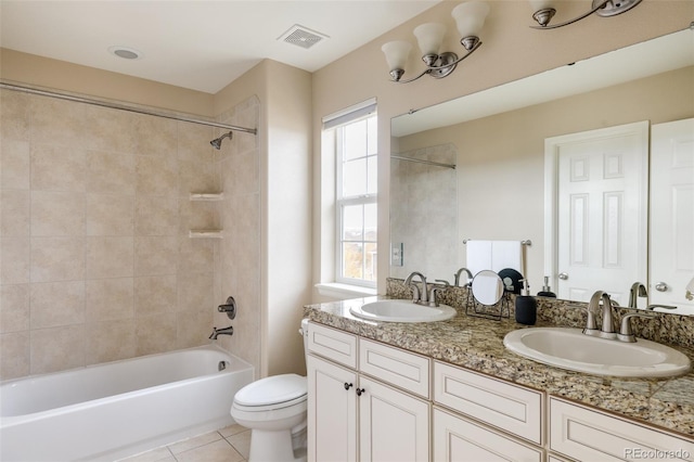 full bathroom with toilet, vanity, a healthy amount of sunlight, and tile patterned floors