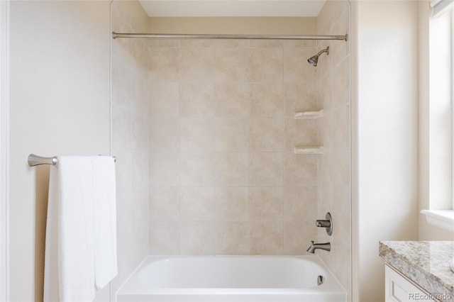 bathroom featuring vanity and tiled shower / bath