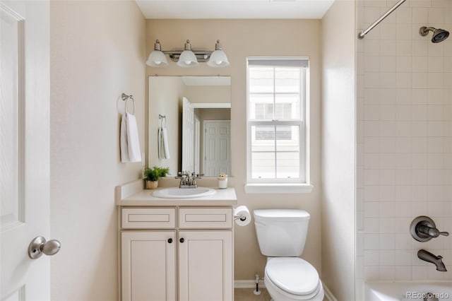 full bathroom featuring toilet, tiled shower / bath combo, and vanity