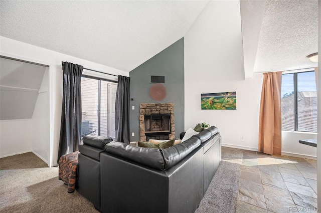 living room with visible vents, a textured ceiling, stone tile flooring, a fireplace, and baseboards