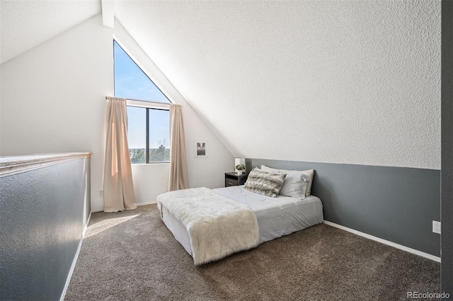 bedroom featuring lofted ceiling, carpet, baseboards, and a textured ceiling