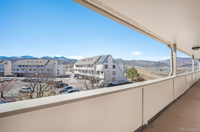 balcony with a residential view and a mountain view