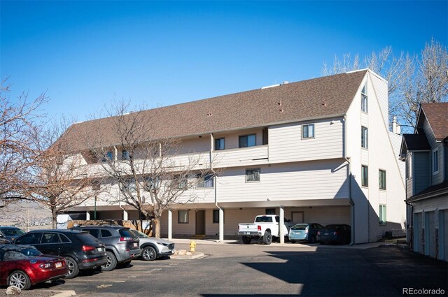 view of property featuring uncovered parking