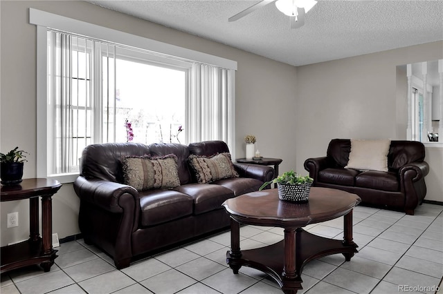 living area with light tile patterned floors, a textured ceiling, and a healthy amount of sunlight