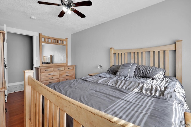 bedroom featuring a textured ceiling, ceiling fan, and wood finished floors