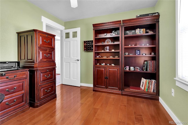 home office featuring light wood finished floors and baseboards