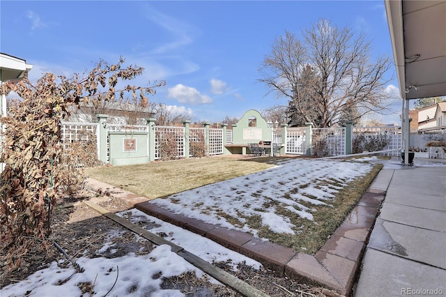 yard covered in snow with fence