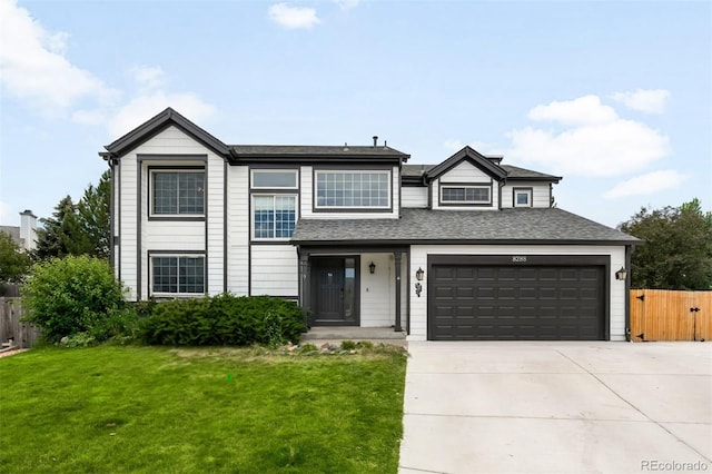 8288 W Chestnut Ave, Littleton, CO 80128 - view of front of home with driveway and a shingled roof