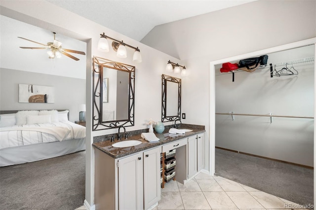 8288 W Chestnut Ave, Littleton, CO 80128 - ensuite bathroom featuring vaulted ceiling, ceiling fan, double vanity, and tile patterned floors