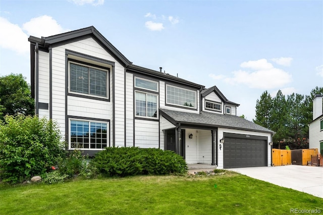 8288 W Chestnut Ave, Littleton, CO 80128 - view of front of house featuring driveway and an attached garage