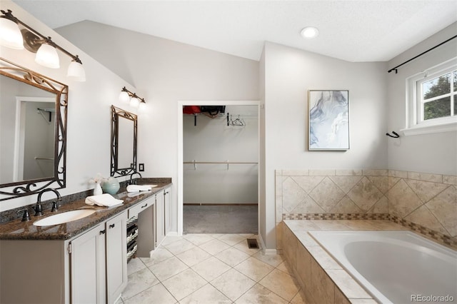 8288 W Chestnut Ave, Littleton, CO 80128 - full bath with double vanity, a garden tub, tile patterned flooring, and a spacious closet
