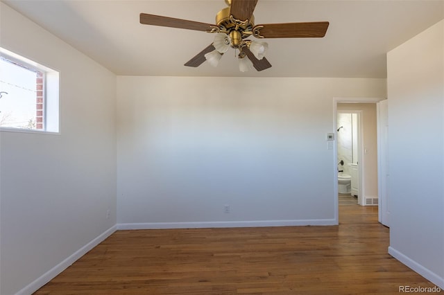 unfurnished room with a ceiling fan, baseboards, and wood finished floors