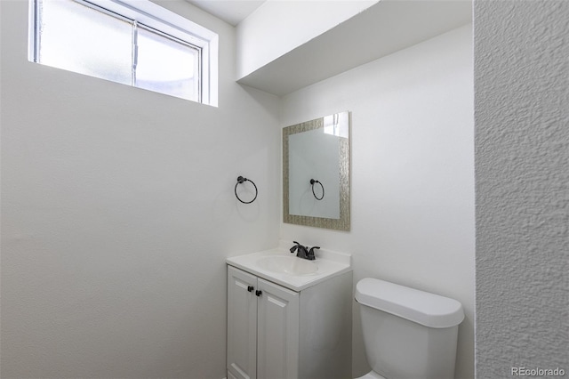 bathroom with toilet and vanity