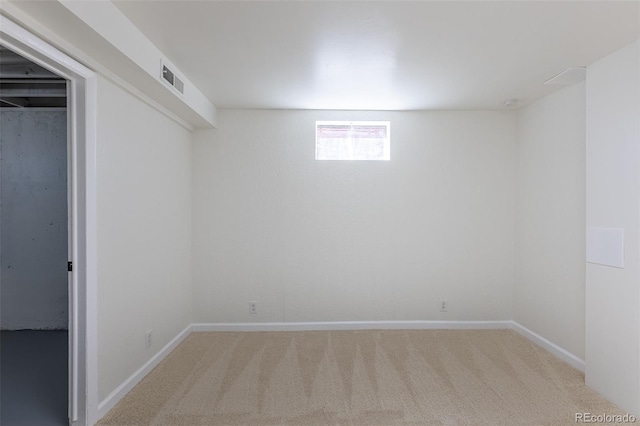 basement featuring visible vents, baseboards, and carpet floors