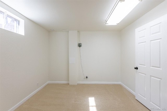 unfurnished room featuring light colored carpet and baseboards