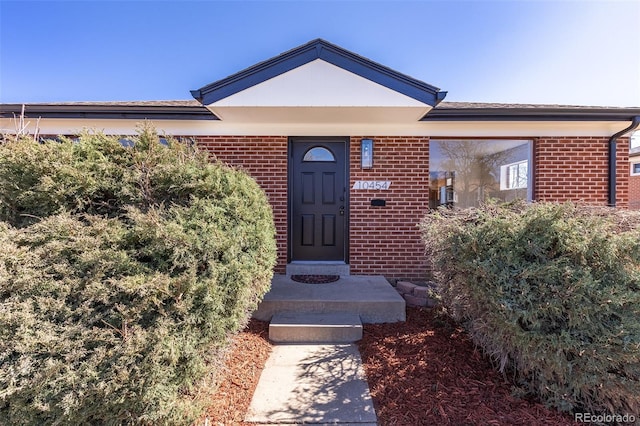 property entrance featuring brick siding