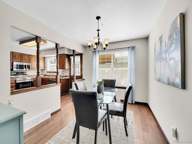 7391 S Knolls Way, Centennial, CO 80122 - dining space featuring a chandelier and light wood-style floors