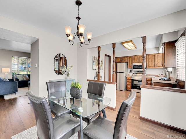 7391 S Knolls Way, Centennial, CO 80122 - dining room with a chandelier and light wood-style floors