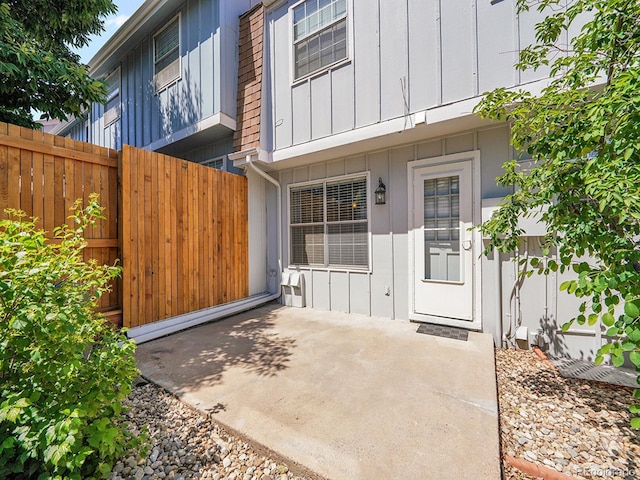 7391 S Knolls Way, Centennial, CO 80122 - doorway to property featuring board and batten siding and a patio area
