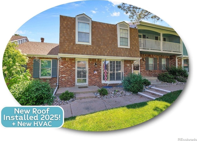 7391 S Knolls Way, Centennial, CO 80122 - view of front of home featuring brick siding and a shingled roof
