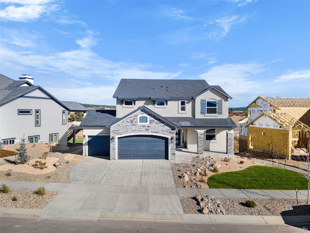 view of front of property featuring stucco siding, driveway, stone siding, a residential view, and an attached garage