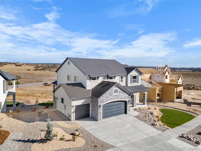 view of front of house featuring driveway, a shingled roof, stucco siding, a garage, and stone siding