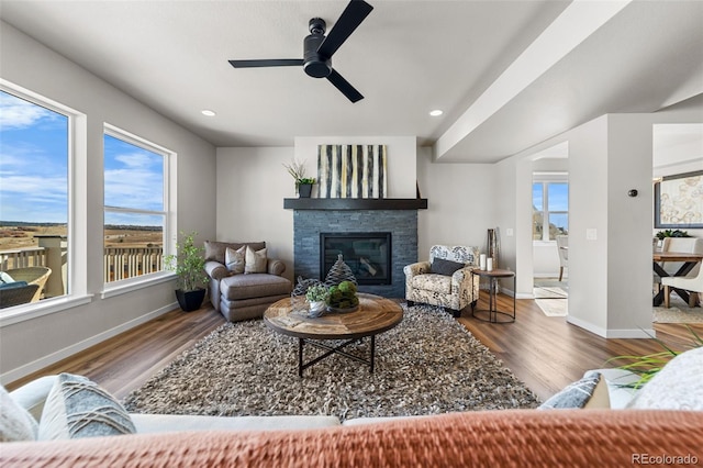 living area with recessed lighting, baseboards, and wood finished floors