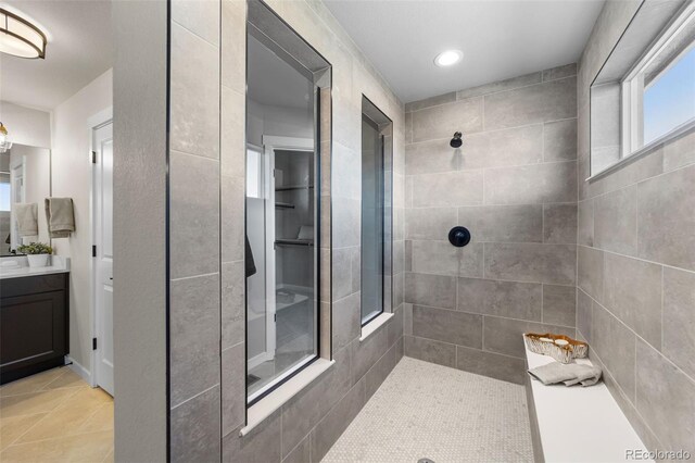 bathroom with tile patterned floors, recessed lighting, vanity, and walk in shower