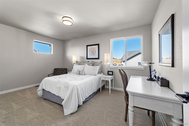 bedroom featuring baseboards and carpet