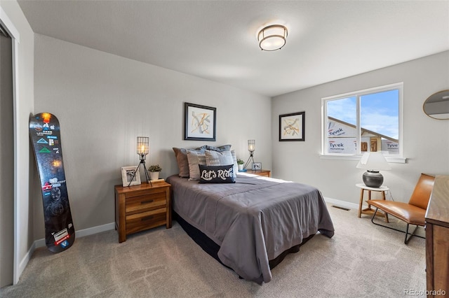 bedroom featuring visible vents, light carpet, and baseboards