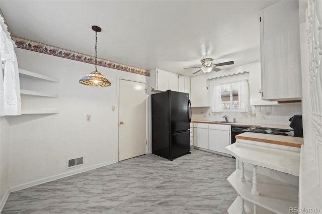 343 Melody Dr, Northglenn, CO 80260 - kitchen featuring a sink, black appliances, visible vents, decorative backsplash, and a ceiling fan
