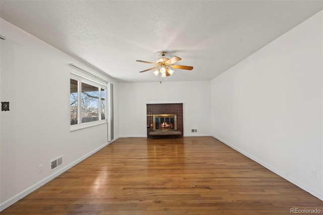 343 Melody Dr, Northglenn, CO 80260 - unfurnished living room featuring a ceiling fan, a textured ceiling, baseboards, visible vents, and wood finished floors