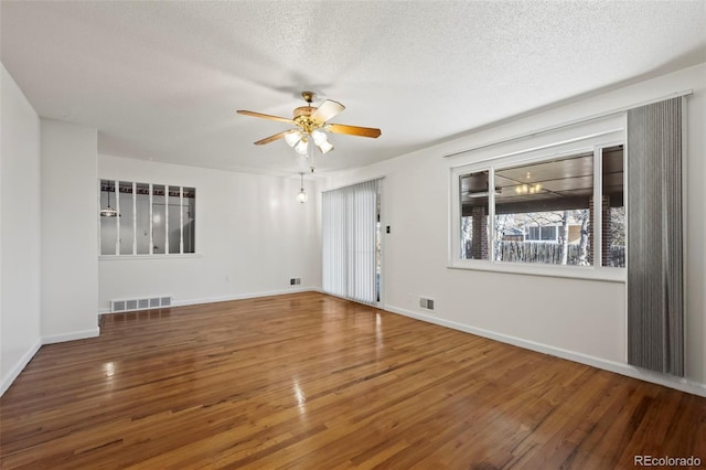 343 Melody Dr, Northglenn, CO 80260 - unfurnished room featuring baseboards, ceiling fan, visible vents, and wood finished floors