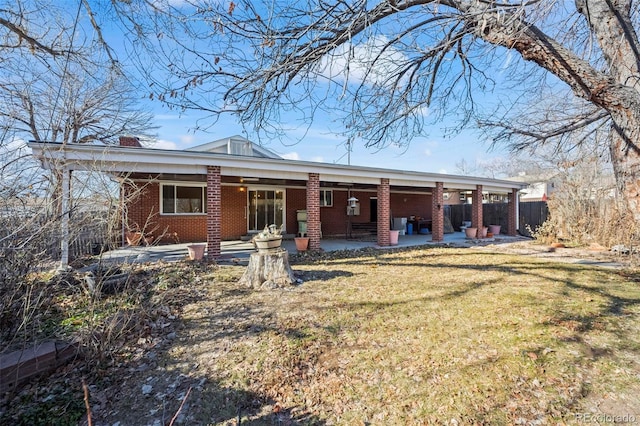 343 Melody Dr, Northglenn, CO 80260 - rear view of property with fence, a patio area, brick siding, a chimney, and a lawn